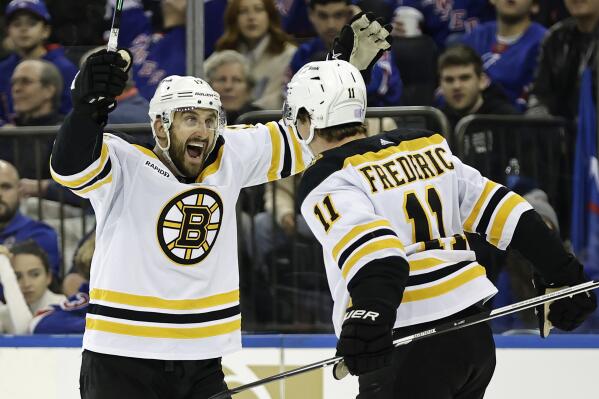 Boston Bruins center Trent Frederic (11) is congratulated by teammate Nick Foligno after scoring a goal against the New York Rangers in the third period of an NHL hockey game Thursday, Nov. 3, 2022, in New York. (AP Photo/Adam Hunger)