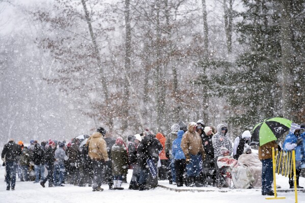 People wait to enter a Trump campaign event during a winter snowstorm in Atkinson, N.H. on Tuesday. (AP Photo/Matt Rourke)