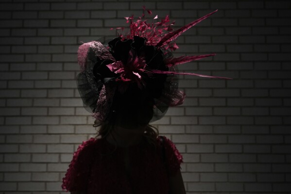 A race fan walks through a tunnel at Churchill Downs before the 151st running of the Kentucky Oaks horse race Friday, May 2, 2025, in Louisville, Ky. (AP Photo/Brynn Anderson)