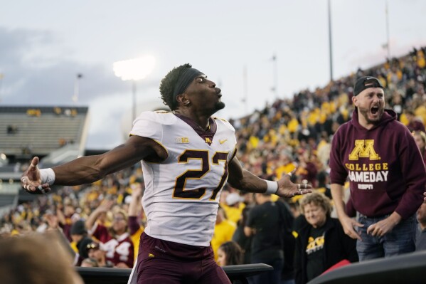 Minnesota defensive back Tyler Nubin (27) celebrates with fans after their 12-10 win over Iowa in a NCAA college football game, Saturday, Oct. 21, 2023, in Iowa City, Iowa. (AP Photo/Matthew Putney)