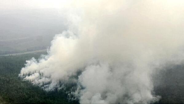 This image taken from video provided by the Russian Emergency Ministry Sunday, June 13, 2021 shows a view of a forest fire in Irkutsk region. To eliminate the emergency situation associated with forest fires in the Katangsky region, an Il-76 aircraft of the Ministry of Emergencies of Russia arrived in the Irkutsk region. As of the morning of June 13, 2021, around 13 wildfires are active in the region on a total area of 34149.4 hectares. (Russian Emergency Ministry Press Service via AP)