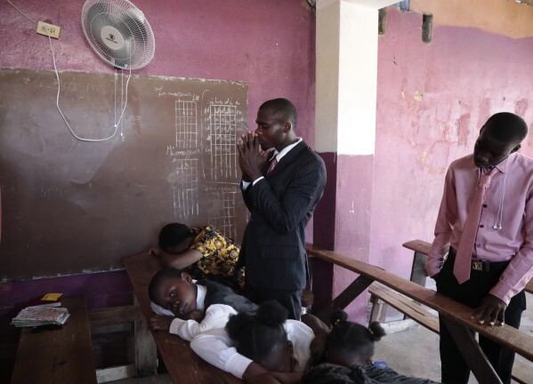 Worshipers pray during service at a Protestant church in Port-au-Prince, Haiti, Sunday, Sept. 24, 2023. (AP Photo/Odelyn Joseph)