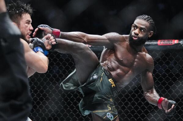 Aljamain Sterling, of Jamaica, kicks Henry Cejudo during the fifth round of a bantamweight title bout at the UFC 288 mixed martial arts event Sunday, May 7, 2023 in Newark, N.J. Sterling won the fight. (AP Photo/Frank Franklin II)