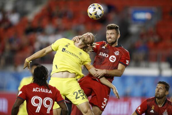 Toronto FC defender Eriq Zavaleta (3) and Nashville SC defender Walker Zimmerman (25) battle for the ball during an MLS soccer game in Toronto, Saturday, Sept. 18, 2021. (Cole Burston/The Canadian Press via AP)