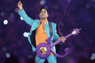 FILE - In this Feb. 4, 2007, file photo, Prince performs during the halftime show at the Super Bowl XLI football game in Miami. The six-year legal battle over pop superstar Prince’s estate has ended, meaning the process of distributing the artist's wealth could begin in February 2022. (AP Photo/Chris O'Meara, File)