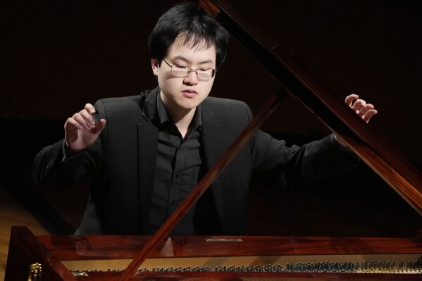 Canadian pianist Eric Guo plays Frederic Chopin's Concerto in F minor on a replica of a 1830 Pleyel piano during a concert marking the 19th century piano virutoso and composer's 214th birthday, in Warsaw, Poland, on Friday, March 1, 2024. Guo won a quintannual competition to play Chopin on period instruments organized by the Fryderyk Chopin Institute. (AP Photo/Czarek Sokolowski)