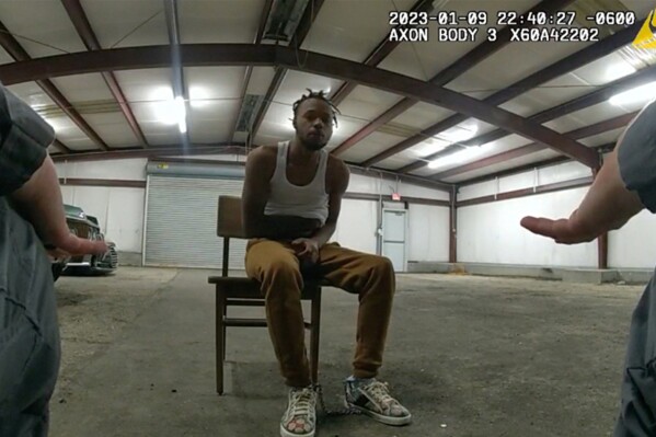 In this image from Baton Rouge Police Department body camera video, officers interact with Jeremy Lee inside a warehouse in Baton Rouge on Jan. 9, 2023. Lee sued the department in August 2023 alleging officers abused him in the police warehouse nicknamed the “Brave Cave.” (Baton Rouge Police Department via AP)