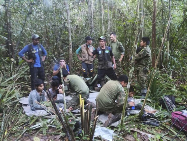 FILE - In this photo released by Colombia's Armed Forces press office, soldiers and Indigenous men tend to the four Indigenous children who were missing for 40 days after surviving a deadly plane crash, in the Solano jungle, Caqueta state, Colombia, June 9, 2023. (Colombia's Armed Force Press Office via AP, File)