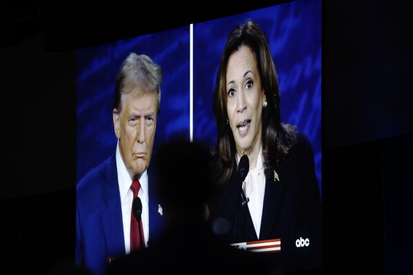 A presidential debate between Republican presidential nominee former President Donald Trump, on screen at left, and Democratic presidential nominee Vice President Kamala Harris, right, is seen from the spin room, Sept. 10, 2024, in Philadelphia. (AP Photo/Matt Rourke)