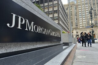 FILE - Pedestrians approach JPMorgan Chase headquarters on Dec. 29, 2023, in New York. JP Morgan reports earnings on Friday, April 12, 2024. (AP Photo/Peter Morgan, File)