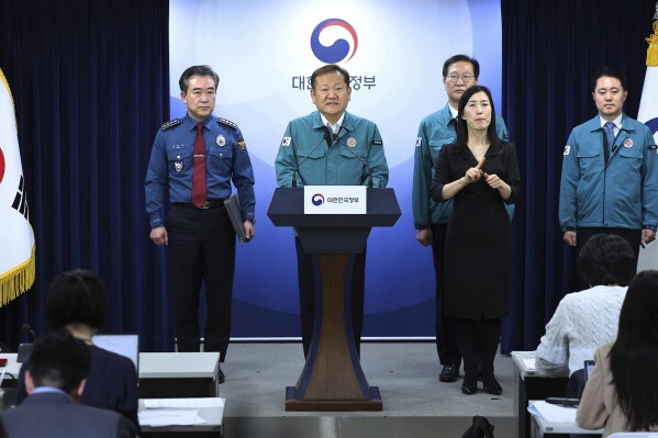 South Korean Interior and Safety Minister Lee Sang-min, center, speaks during a joint government briefing at the government complex in Seoul, South Korea, Wednesday, Feb. 21, 2024. South Korea on Wednesday officially ordered thousands of striking doctors to return to work immediately, a step that could lead to legal punishments if the doctors don't end their walkouts, which have caused numerous cancellations of surgeries and other treatments at hospitals. (Kim Do-hoon/Yonhap via AP)