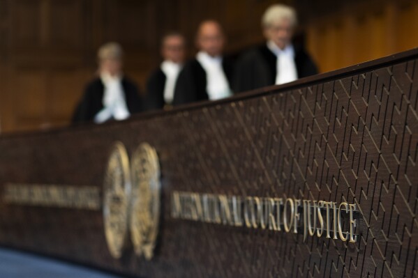 Judges enter the International Court of Justice, in The Hague, Netherlands, Thursday, May 16, 2024. The U.N.'s top court opened two days of hearings in a case brought by South Africa to see whether Israel needs to take additional measures to alleviate the suffering in war-ravaged Gaza. (AP Photo/Peter Dejong)