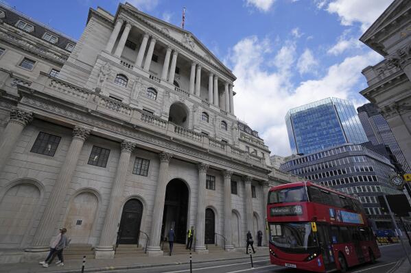 A bus drives past the Bank of England before the release of the Monetary Policy Report at the Bank of England in London, Thursday, May 5, 2022. (AP Photo/Frank Augstein)