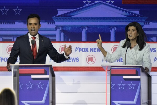 Businessman Vivek Ramaswamy, left, and former U.N. Ambassador Nikki Haley speak during a Republican presidential primary debate hosted by FOX News Channel, Aug. 23, 2023, in Milwaukee. 