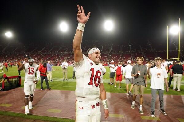 Utah quarterback Bryson Barnes waves to fans after Utah defeated Southern California 34-32 in an NCAA college football game Saturday, Oct. 21, 2023, in Los Angeles. (AP Photo/Mark J. Terrill)