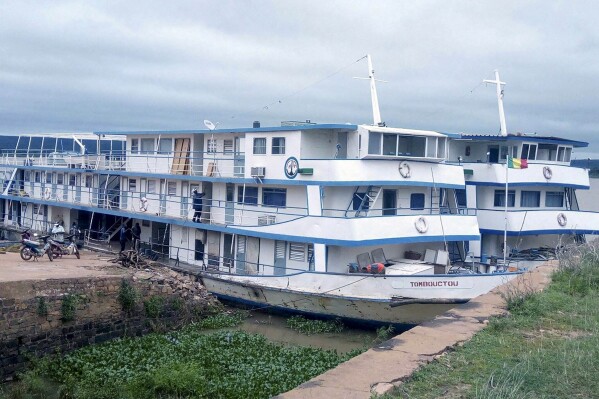 This undated photograph released by the Compagnie Malienne de Navigation (COMANAV) shows their boat called Tombouctou at dock on the Niger River in Mali. A Malian government statement said the passenger boat was attacked near the village of Zarho, about 90 kilometers (55 miles) east of Timbuktu Thursday, Sept. 7, 2023. Al-Qaida-linked insurgents killed 49 civilians and 15 government soldiers in two separate assault, the boat, and a military camp, the military said. (Comanav via AP)