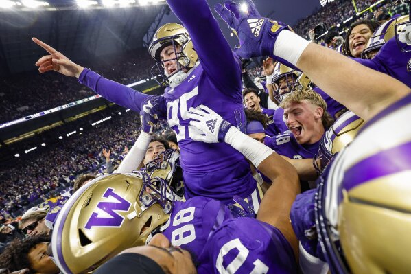 Washington's Grady Gross is carried off the field after kicking the winning field goal against Washington State during an NCAA college football game Saturday, Nov. 25, 2023, in Seattle. (Dean Rutz/The Seattle Times via AP)