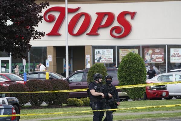 FILE - Police secure an area around a supermarket where several people were killed in a shooting, Saturday, May 14, 2022, in Buffalo, N.Y.  New York’s new law barring sales of bullet-resistant vests to most civilians doesn't cover the type of armor worn by the gunman who killed 10 people at the Buffalo supermarket, a gap that could limit its effectiveness in deterring future military-style assaults. (Derek Gee/The Buffalo News via AP, File)