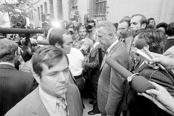 FILE - Spiro T. Agnew, who recently resigned from the vice presidency, talks a member of the media after he pleaded no contest to a federal tax evasion charge, outside the Federal Court building in Baltimore, Oct. 10, 1973. The last time Secret Service agents delivered a U.S. leader to face criminal charges, they kept their mission a secret, even from their own bosses. It was Oct. 10, 1973, and just a few agents knew the historic role they were playing in ensuring that Agnew appeared in a federal courtroom to enter a plea and resign from office. (AP Photo, File)