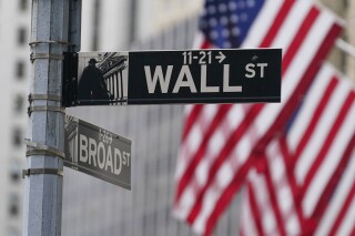 FILE - A street sign is seen in front of the New York Stock Exchange in New York, Tuesday, June 14, 2022. AP Photo/Seth Wenig, File)