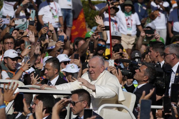 Pope Francis waves on arrival to take part in a via crucis (Way of the Cross) at the Eduardo VII Park with young people in Lisbon, Friday, Aug. 4, 2023. Pope Francis is on the third day of a five-day pastoral visit to Portugal that includes the participation at the 37th World Youth Day, and a pilgrimage to the holy shrine of Fatima. (AP Photo/Gregorio Borgia)