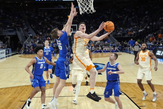 Tennessee guard Dalton Knecht (3) attempts a layup as Creighton guard Baylor Scheierman (55) defends during the second half of a Sweet 16 college basketball game in the NCAA Tournament, Friday, March 29, 2024, in Detroit. (AP Photo/Paul Sancya)