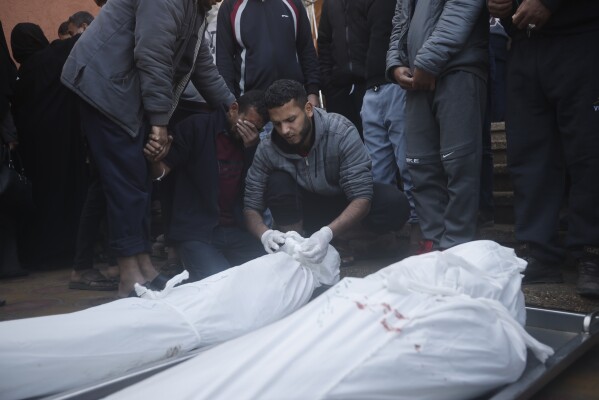 Palestinians attend the funeral of their relatives killed in the Israeli bombardment of the Gaza Strip in Khan Yunis, Wednesday, Dec. 6, 2023.  (AP Photo/Mohammed Dahman)