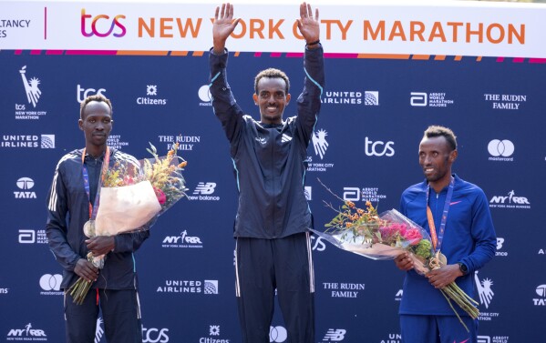From left, second place finisher Albert Korir of Kenya, first place finisher Tamirat Tola, of Ethiopia, and third place finisher Shura Kitata, also from Ethiopia, pose after the men's division of the New York City Marathon, Sunday, Nov. 5, 2023, in New York.(AP Photo/Craig Ruttle)