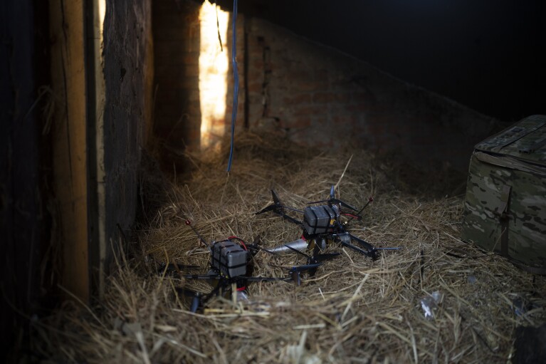 Exploding drones loaded with shells lay inside a hay barn on the front line in the outskirts of Kremmina, Ukraine, Sunday, Aug. 20, 2023. (AP Photo/Bram Janssen)