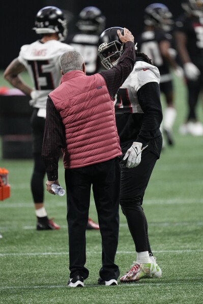Atlanta Falcons owner Arthur Blank greets running back Cordarrelle Patterson (84) during the the team's NFL minicamp football practice, Tuesday, June 13, 2023, in Atlanta. (AP Photo/John Bazemore)