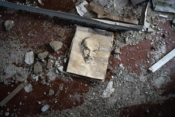 A hand-drawn portrait of Russian revolutionary Vladimir Lenin lies among debris in a classroom of the destroyed School Number 23 after a Russian attack that occurred in the second half of July, in Kramatorsk, Ukraine, Saturday, Aug. 27, 2022. (AP Photo/Leo Correa)