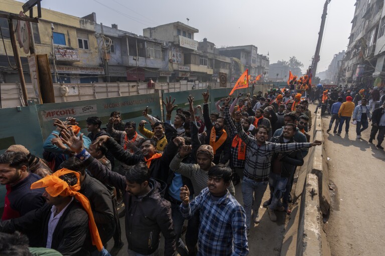 Hindu men shout slogans during a procession in New Delhi, India, Tuesday, Jan. 16, 2024. (AP Photo/Altaf Qadri)
