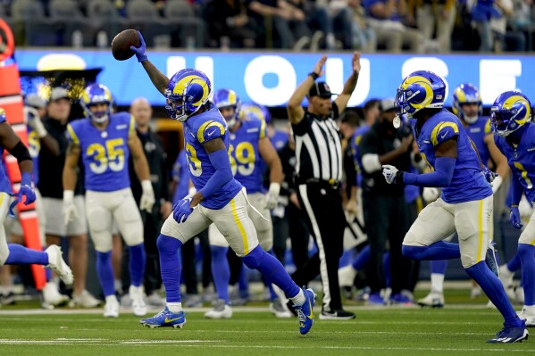 Los Angeles Rams safety John Johnson III, left, celebrates after intercepting a pass intended for Washington Commanders wide receiver Terry McLaurin during the second half of an NFL football game against the Washington Commanders Sunday, Dec. 17, 2023, in Los Angeles. (AP Photo/Ryan Sun)