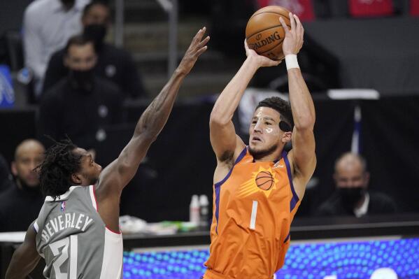 Phoenix Suns guard Devin Booker, right, shoots as Los Angeles Clippers guard Patrick Beverley defends during the first half in Game 4 of the NBA basketball Western Conference Finals Saturday, June 26, 2021, in Los Angeles. (AP Photo/Mark J. Terrill)