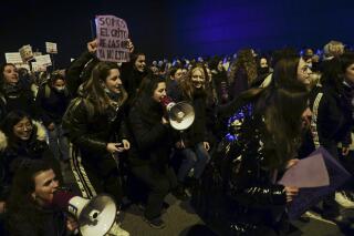 FILE - People gather during a demonstration on International Women's Day, in Pamplona, northern Spain, on March 8, 2022. Spain’s government presented Tuesday March 7, 2023 a plan to mandate gender quotas in elected government bodies and companies' executive boards on the eve of an International Women’s Day when thousands will take to streets of Madrid and other cities for women’s rights. (AP Photo/Alvaro Barrientos, File)