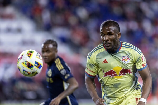 New York Red Bulls forward Elias Manoe, right,l chases the ball during an MLS soccer match against the Vancouver Whitecaps, Saturday, April 27, 2024, in Harrison, N.J. (AP Photo/Stefan Jeremiah)