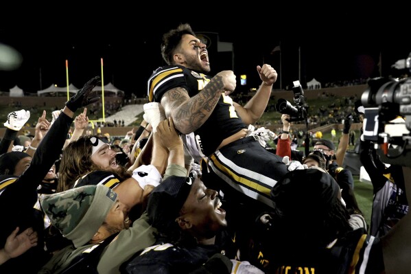 Missouri running back Cody Schrader lets out celebratory yell as he is hoisted up by his teammates after an NCAA college football game against Tennessee in Columbia, Mo., on Saturday, Nov. 11, 2023. (David Carson/St. Louis Post-Dispatch via AP)