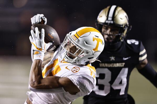 FILE -Tennessee wide receiver Jalin Hyatt (11) catches a pass in front of Vanderbilt defensive back Ja'Dais Richard (34) during the first half of an NCAA college football game Saturday, Nov. 26, 2022, in Nashville, Tenn. All-American wide receiver Jalin Hyatt will watch his sixth-ranked Tennessee Volunteers play No. 10 Clemson in the Orange Bowl from the sideline after announcing Wednesday, Dec. 14, 2022 he is leaving after his junior season for the NFL draft.(AP Photo/Wade Payne, File)