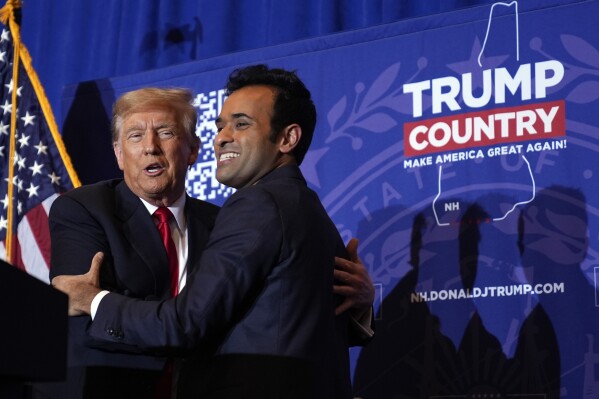 Former Republican presidential candidate businessman Vivek Ramaswamy embraces Republican presidential candidate former President Donald Trump during a campaign event in Atkinson, N.H., Tuesday, Jan. 16, 2024. (AP Photo/Matt Rourke)