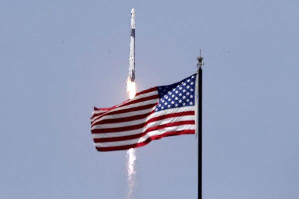 FILE - A SpaceX Falcon 9, with NASA astronauts Doug Hurley and Bob Behnken in the Dragon crew capsule, lifts off from Pad 39-A at the Kennedy Space Center in Cape Canaveral, Fla., Saturday, May 30, 2020. (AP Photo/John Raoux, File)