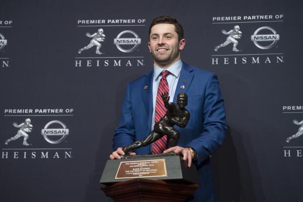FILE - Oklahoma quarterback Baker Mayfield, winner of the Heisman Trophy, poses with the award Saturday, Dec. 9, 2017, in New York. Oklahoma has announced it will publicly dedicate a statue of 2017 Heisman Trophy winner Baker Mayfield on April 23, 2022, immediately following the school’s Spring Game. “I’m a Sooner for life and incredibly grateful for all of the success my teammates and I had at OU,” Mayfield said in a statement. “It’s humbling and surreal to think about having a statue in iconic Heisman Park. I can’t wait to be back in Norman and reunite with the most passionate fans in college football.” (AP Photo/Craig Ruttle, File)