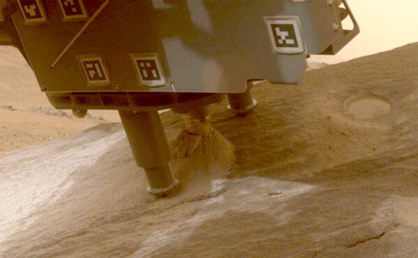 This photo provided by NASA shows the Perseverance Mars rover collecting a sample from a rock called "Bunsen Peak" using a coring bit on the end of its robotic arm on March 11, 2024. NASA has put the effort to bring the samples to Earth on hold until there is a faster, cheaper way. (NASA/JPL-Caltech/ASU via AP)