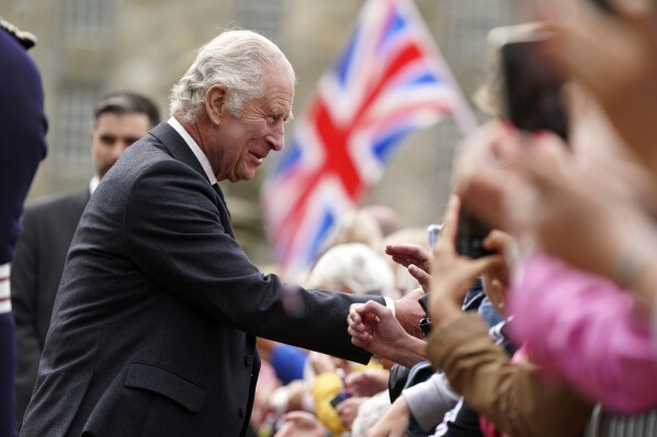 FILE - Britain's King Charles III meets members of the public during his visit to Kinneil House in Edinburgh, Scotland, Monday, July 3, 2023. At an age when many of his contemporaries have long since retired, King Charles III is not one to put his feet up. The king will mark his 75th birthday on Tuesday, Nov. 14, 2023, by highlighting causes close to his heart. With Queen Camilla at his side, Charles will visit a project that helps feed those in need by redistributing food that might otherwise go to landfills. (Andrew Milligan/Pool Photo via AP, File)