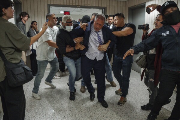 New York City Comptroller Brad Lander is placed under arrest by Immigration and Customs Enforcement (ICE) and FBI agents outside federal immigration court on Tuesday, June 17, 2025, in New York. (AP Photo/Olga Fedorova)
