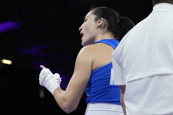 Italy's Angela Carini speaks with her corner in after abandoning her fight against Algeria's Imane Khelif in their women's 66kg preliminary boxing match at the 2024 Summer Olympics, Thursday, Aug. 1, 2024, in Paris, France. (AP Photo/John Locher)