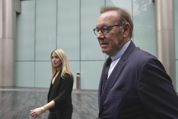 Actor Kevin Spacey, right, arrives at the Southwark Crown Court after lunch break in London, Britain, Friday, July 14, 2023. Kevin Spacey to be cross-examined by prosecution in sex offences trial. The Oscar-winning actor, 63, has previously denied 12 charges, including sexual assault and indecent assault, alleged to have been committed between committed over more than a decade. (AP Photo/Kin Cheung)
