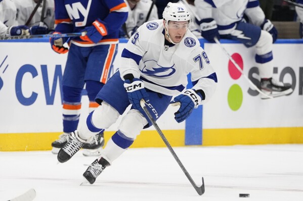FILE - Tampa Bay Lightning's Ross Colton (79) skates with the puck during the first period of an NHL hockey game against the New York Islanders, April 6, 2023, in Elmont, N.Y. The Colorado Avalanche have acquired forward Colton from Tampa Bay Wednesday, June 28, and are expected to lose J.T. Compher to free agency. A person with knowledge of the situation tells The Associated Press that Compher is testing the free agent market. Colton scored in the clinching game when the Lightning won the Stanley Cup in 2021. (AP Photo/Frank Franklin II, File)