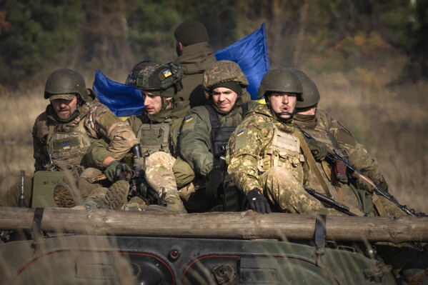 A soldier of the Ukraine's National Guard 1st brigade Bureviy (Hurricane) ride an APC during combat training at a military training ground in the north of Ukraine Friday, Nov. 3, 2023. (AP Photo/Efrem Lukatsky)