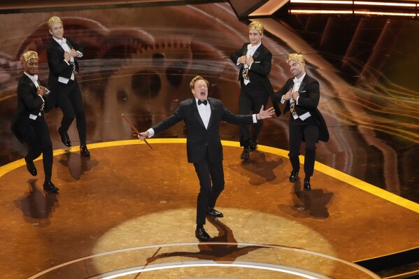 Host Conan O'Brien, center, performs during the Oscars on Sunday, March 2, 2025, at the Dolby Theatre in Los Angeles. (AP Photo/Chris Pizzello)