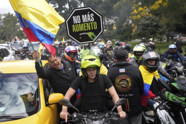 Motorcycle riders hold a caravan to protest the increase in gas prices in Bogota, Colombia, Monday, Aug. 28, 2023. (AP Photo/Fernando Vergara)